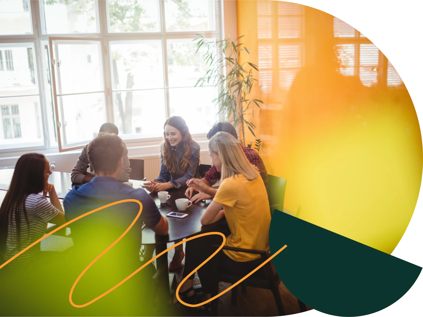 A meeting of several people at a round table in a bright office – David Zelenka